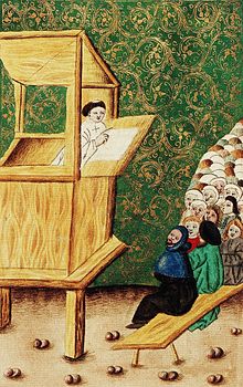 Jan Hus prêchant, probablement à la chapelle de Bethléem de Prague. Un homme prêche depuis une chaire de bois, son auditoire assis à la gauche de la peinture.