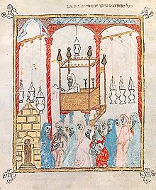 Un chantre lisant le récit de la Pâque dans une synagogue d'Al-Andalus — illustration d'une Haggada de Barcelone, XIVe siècle.