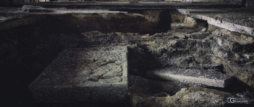 Gravestone and bones in an abandoned church